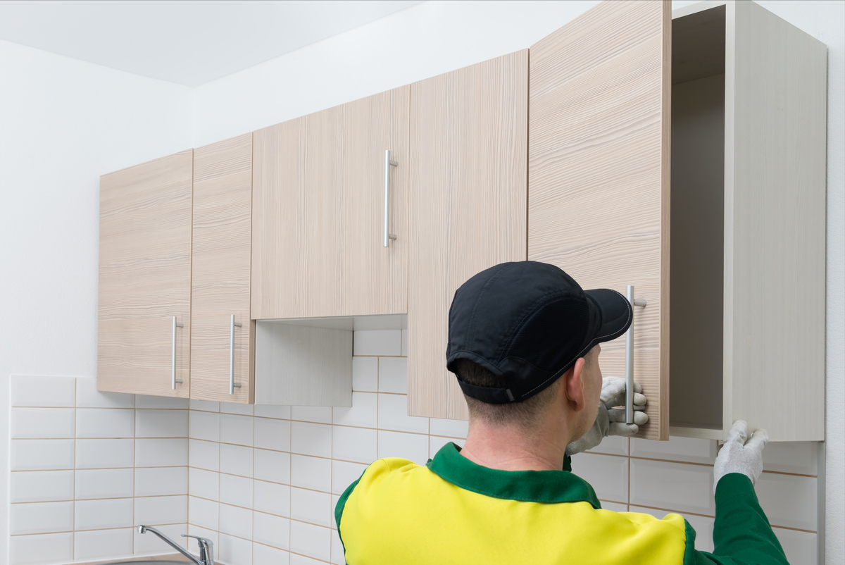 a guy installing cabinet doors